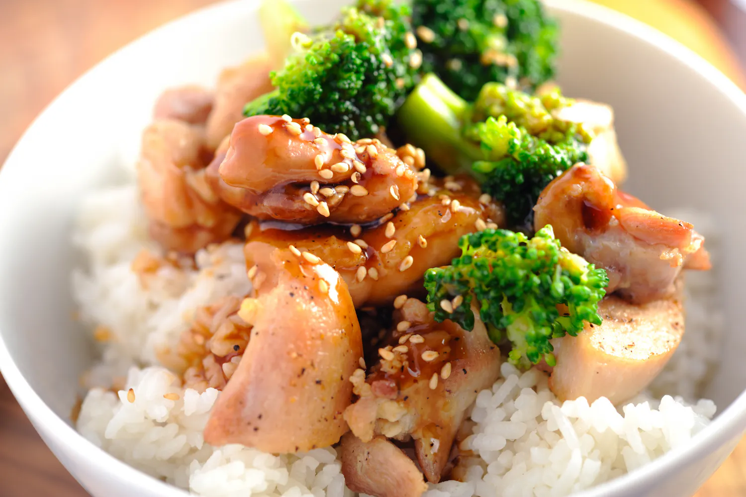 Teriyaki chicken rice bowl with broccoli and sesame seeds